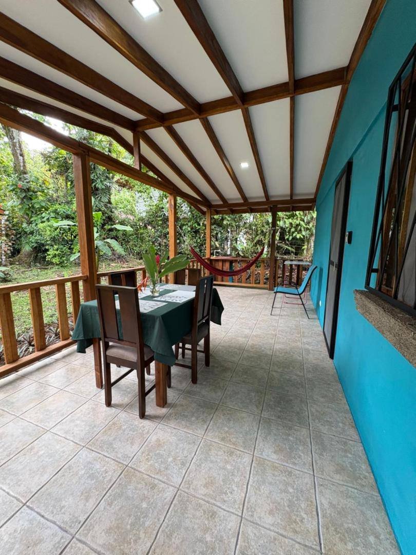 Large covered porch with a table and chairs